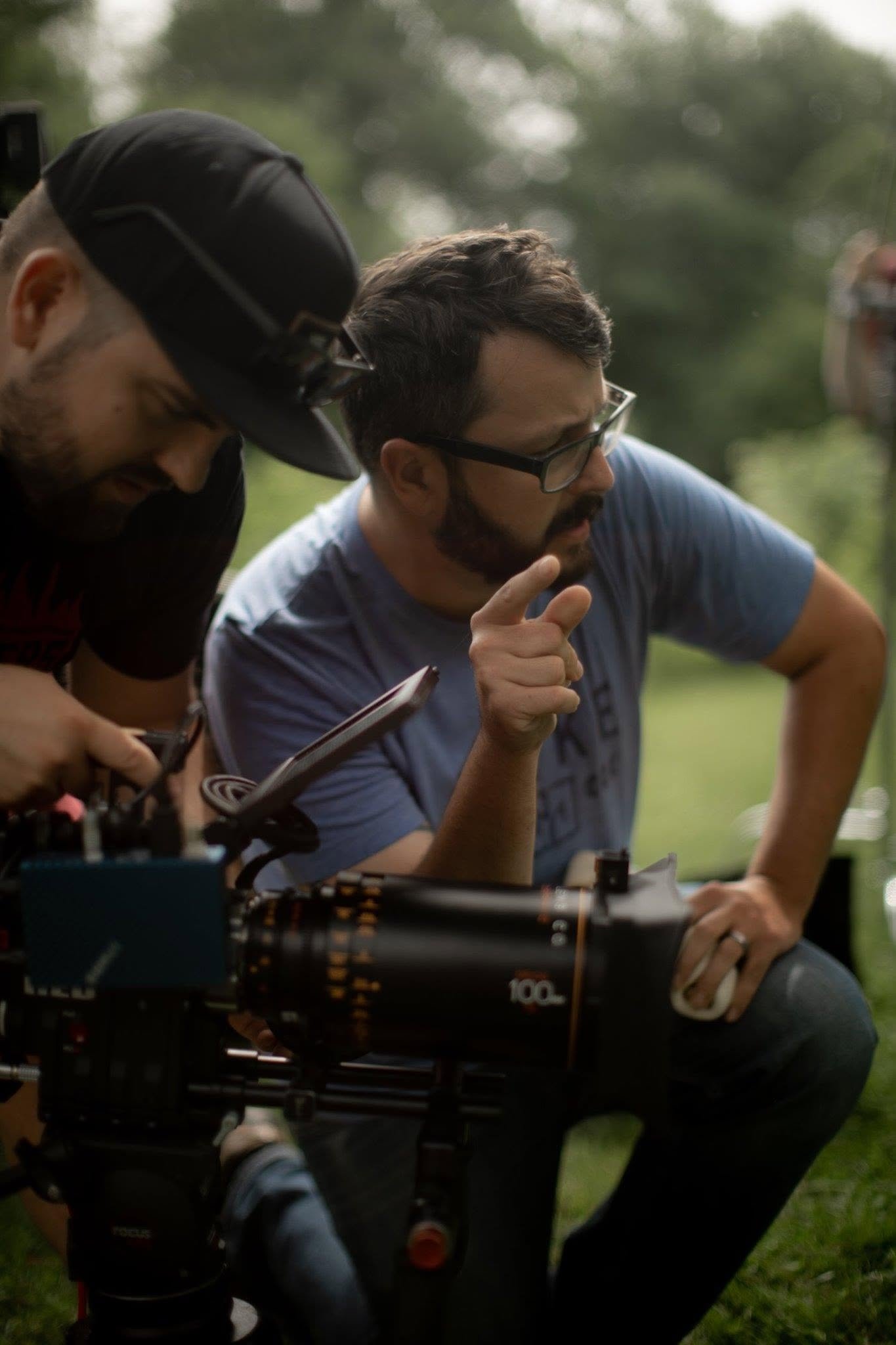 Allen Clements directing a film beside a cinema camera during an outdoor production
